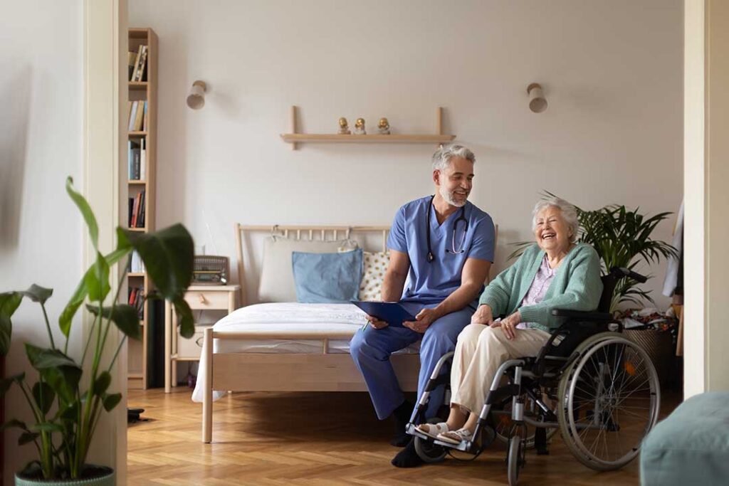 Staff guide older residents through an assisted living evacuation drill with emergency supplies nearby.